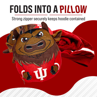 A plush bison mascot pillow in red and brown with a white IU logo, shown with a red hooded garment behind it on a red, white, and black graphic background. Text at the top reads 'FOLDS INTO A PILLOW' and 'Strong zipper securely keeps hoodie contained.
