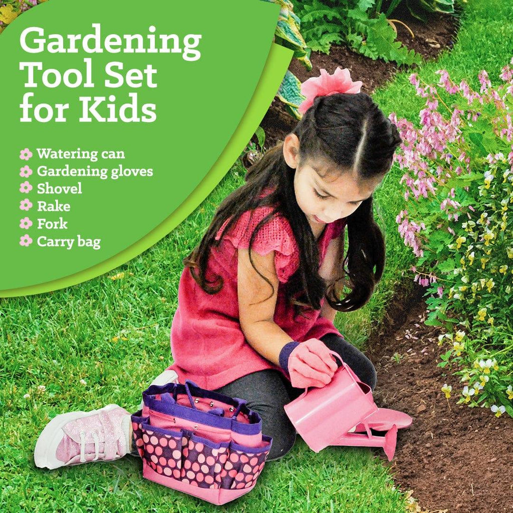 young girl using pink gardening set outside