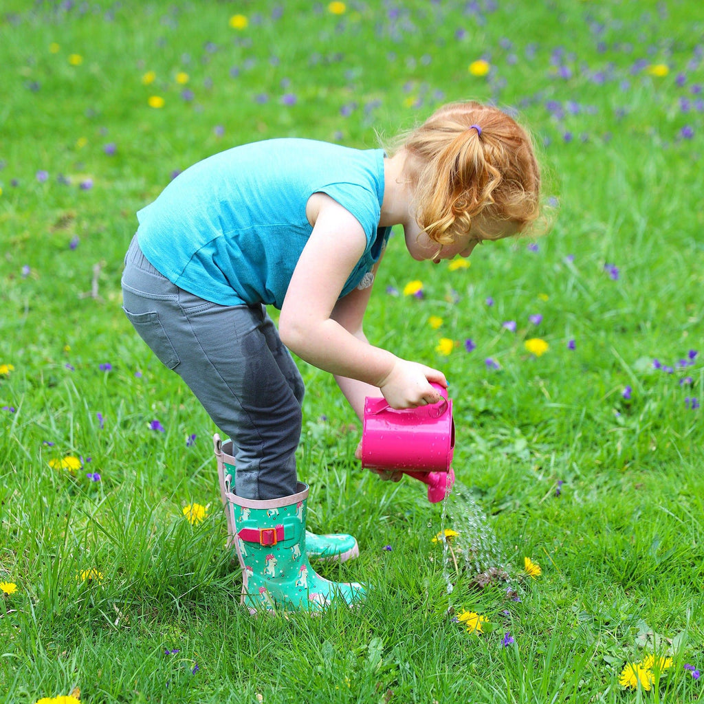 young girl watering weeds