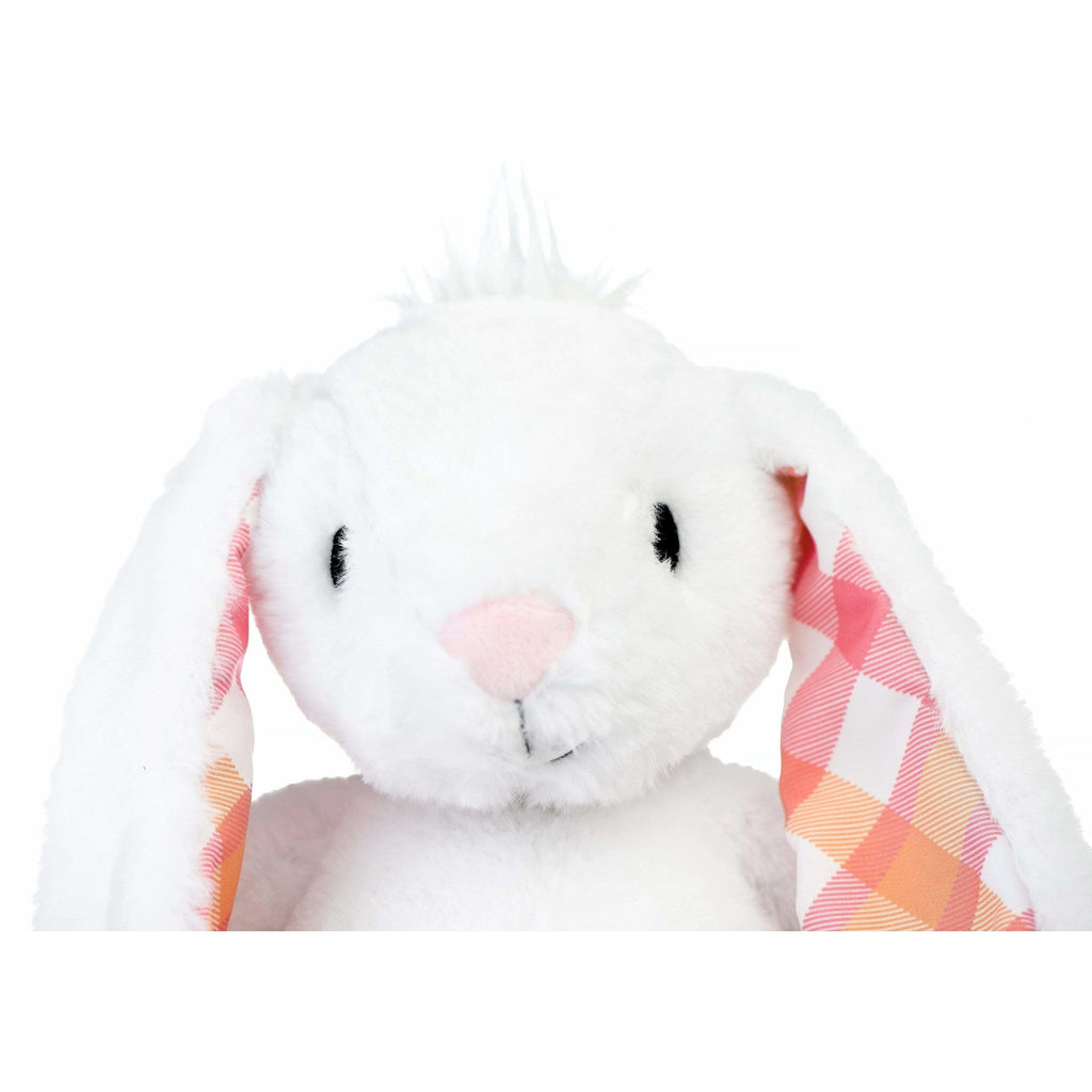 face of large white plush rabbit